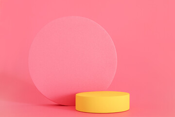 Yellow podium on the pink background. Podium for product, cosmetic presentation. Free space, copy space for text or logo. Pedestal or platform for beauty products.