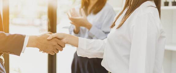 Close-up two business men holding hands, Two businessmen are agreeing on business together and...