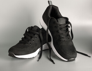 Black sports shoes on a uniform background