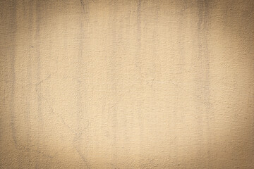 Fototapeta premium Yellow brown weathered cement concrete wall with water streaks and old texture, for backgrounds, design, templates