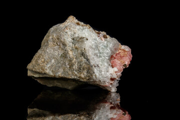 Macro of the mineral stone Rhodochrosite with fluorite on a black background