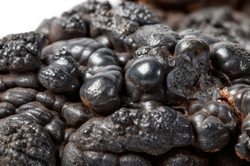 Macro mineral Hematite stone on a white background close-up