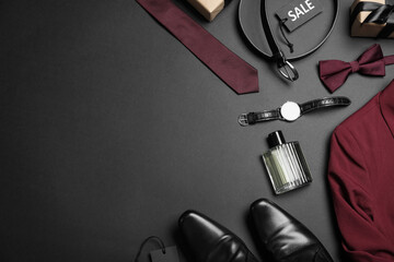 Flat lay composition with men's clothes and accessories on dark background, space for text. Black Friday sale