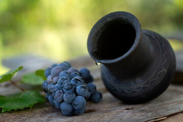Fresh Black Grapes in Dark Wooden Tray on Wooden Table Selective focus
