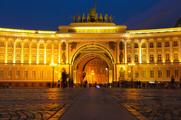 Night landscape with the building of the Winter Palace illuminated by lanterns on Palace Square in St. Petersburg.