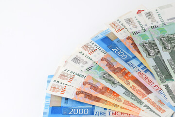 Russian rubles are fanned out on a white background. Currency exchange. Financial crisis, ruble devaluation concept. Selective focus. Top view, flat lay.