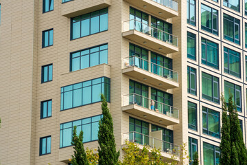 Beige house with balconies and blue windows