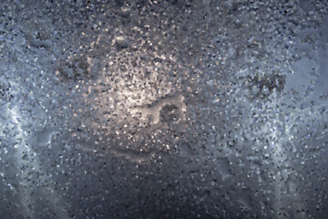 abstract background of gray color from a drop of water on a glass surface. View from above.