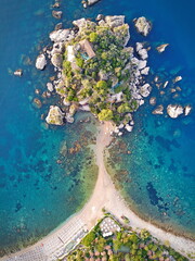 Isola Bella small island near Taormina, Sicily, southern Italy. Narrow path connects Isola Bella island to mainland Taormina beach surrounded by azure waters of the Ionian Sea.