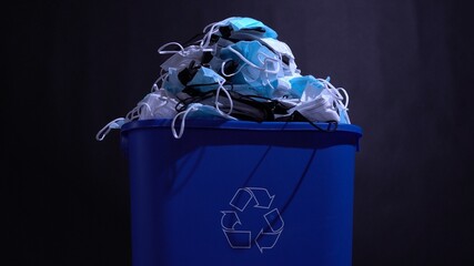 Discarded medical masks waste due coronavirus. Pile of used surgical mask garbage in the bin. Covid...