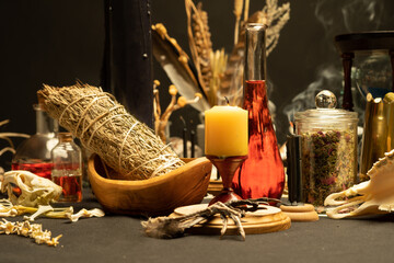 Fototapeta na wymiar Witchcraft still life with witch weeds selective focus at front. Esoteric gothic and occult witch table for Halloween. Various magic objects and ritual arrangement with symbols. Gothic Halloween.
