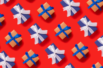 Lots of Christmas gift boxes on a red background. Top view, flat lay