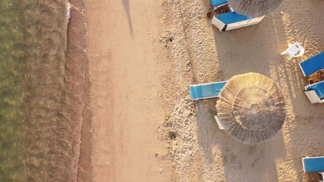 Beautiful beach. Chairs on the sandy beach near the sea. Summer holiday and vacation concept for tourism. The best beaches in world. Top view of the beach of the Egypt on shore of blue sea.