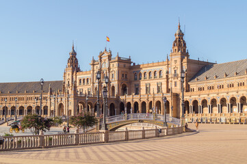 View of the Plaza de España (Spanish Square) in Seville on a sunny morning (Andalusia, Spain). Tourists visiting one of the most emblematic places and architectural work in the city. 