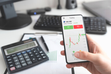 Investor using stock market trading mobile app