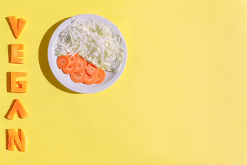 Text. Vegan. Dish with vegetables. Veganism day concept. Backgrounds for design.