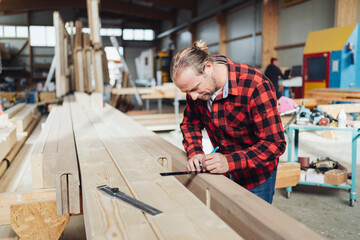 Carpenter working in an industrial woodworking factory
