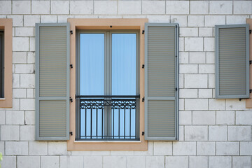 Gray plastic window shutters on a residential building