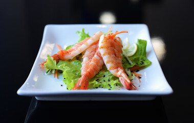 Fresh summer salad with shrimp on white dish. Concept of healthy eating.