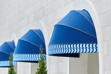 Exterior blue round awning mounted in arch - obrazy, fototapety, plakaty