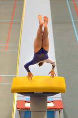 Young gymnast girl performing jump