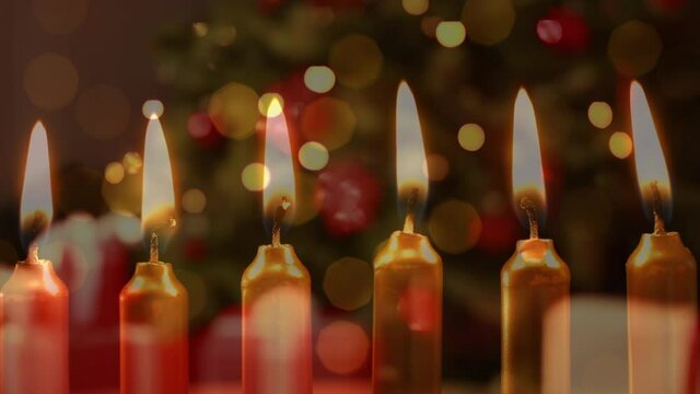 Animation of candles over christmas tree and presents