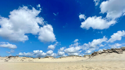 Dunes with Fluffy Clouds and Blue Sky