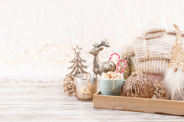 Cup with a hot drink, marshmallow on a table with christmas decorations.