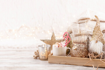 Fototapeta premium Cup with a hot drink, marshmallow on a table with christmas decorations.