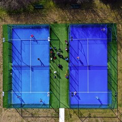 Aerial view of Paddle tennis court with unrecognizable athletes seen from above playing a game of...