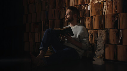 portrait of a person in the dark with the book