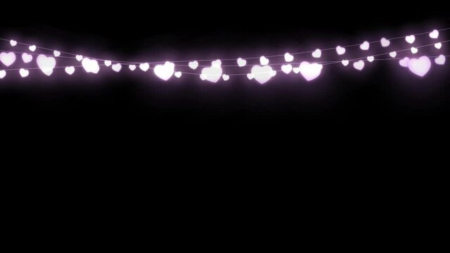 Digital animation of purple decorative heart shaped fairy lights hanging against black background