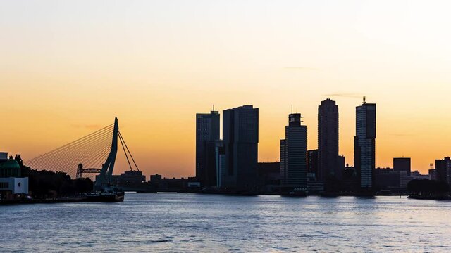 Time-lapse of the sunrise in the Rotterdam harbor, viewing towards the Erusmus bridge, Hotel New York and over the river the Maas.