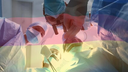 Animation of flag of germany waving over surgeons in operating theatre - Powered by Adobe