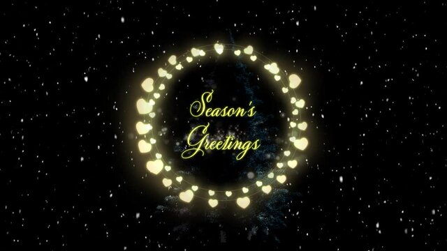 Animation of seasons greetings text in fairy lights frame over snow falling on black background