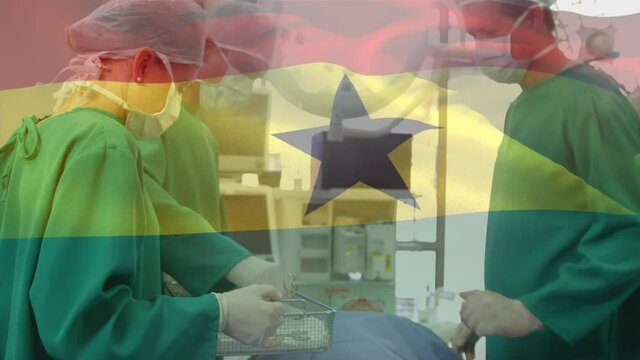Animation of flag of ghana waving over surgeons in operating theatre