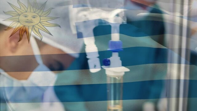 Animation of flag of uruguay waving over surgeons in operating theatre
