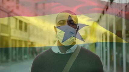 Animation of flag of ghana waving over man wearing face mask during covid 19 pandemic - Powered by Adobe