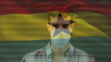 Animation of flag of ghana waving over man wearing face mask during covid 19 pandemic - Powered by Adobe