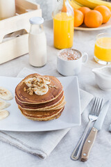 Pancakes with coffee and juice on a light background