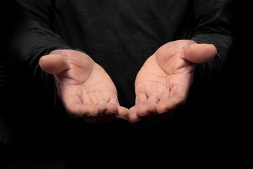 man praying with praying hands on black background stock photo	