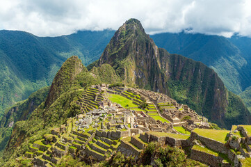 Machu Picchu inca ruins with dramatic clouds, Cusco, Peru.