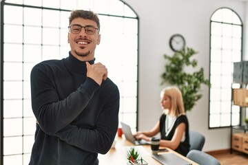 Two business workers smiling happy working. Man standing at the office.