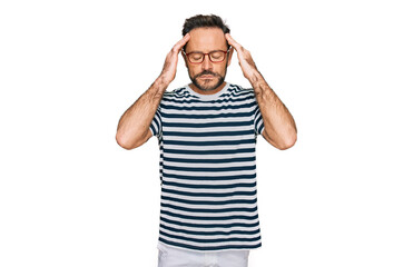 Fototapeta premium Middle age man wearing casual clothes and glasses with hand on head for pain in head because stress. suffering migraine.