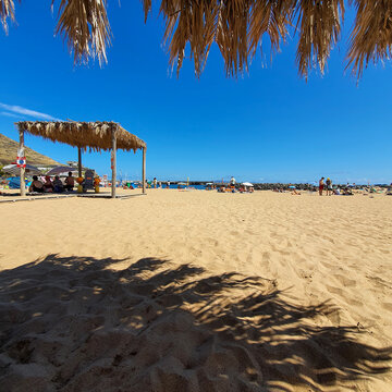 beach with umbrella and chairs