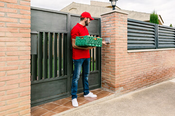 Postman or delivery man carrying small box food delivery to customer at home - Food delivery service and small business concept