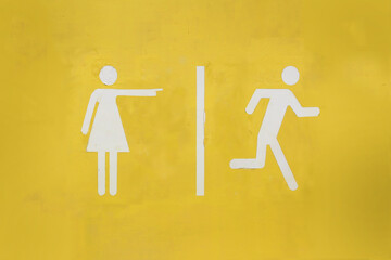 WC toilet sign with women pointing at men running away printed over yellow background, concept