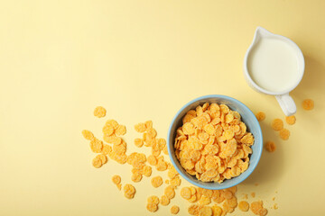 Golden and crunchy cornflakes on a colored background close-up