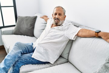 Fototapeta premium Senior grey-haired man smiling confident at home