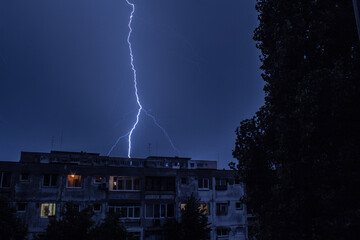 On a stormy evening, the sky unleashes lightnings above the city of Bucharest.